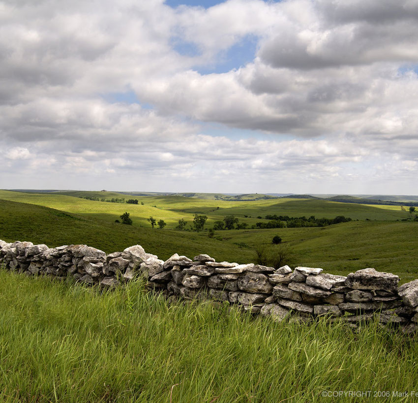 Green field with stone wall