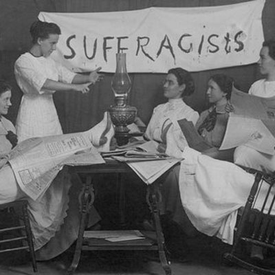 Suffragists sitting around a table