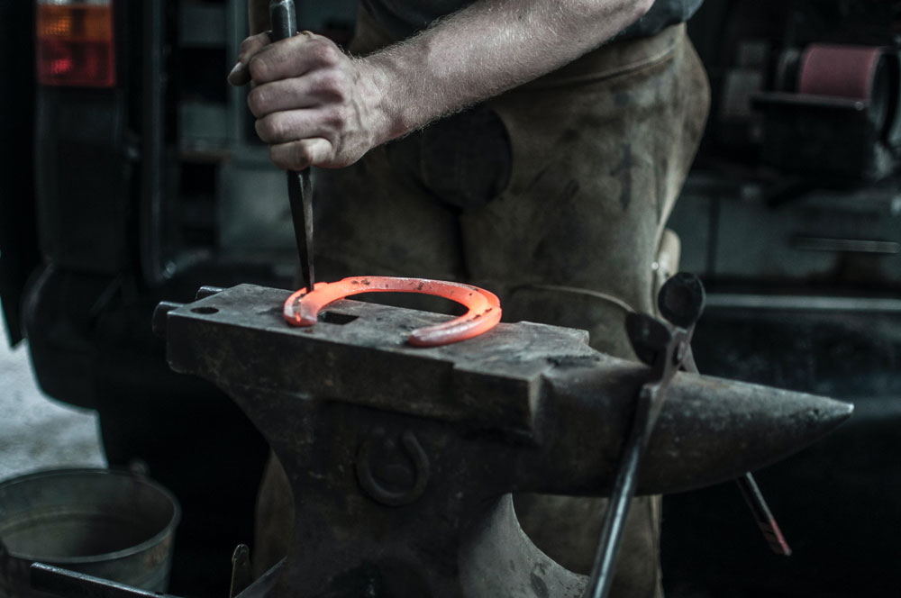 Blacksmith working with a horseshoe