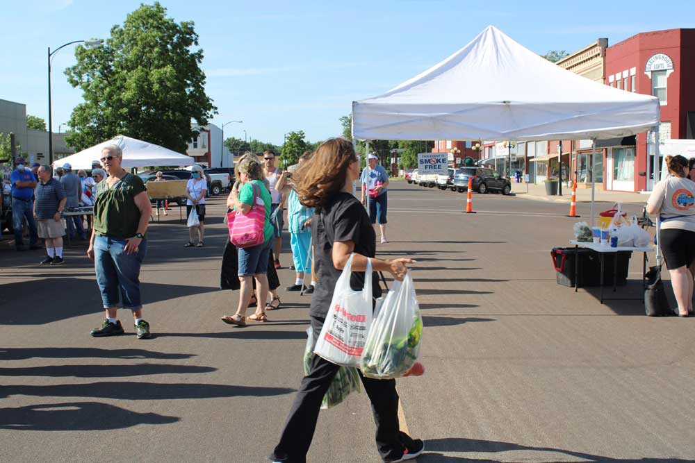 Iola residents gathering at the Iola Farmer's Market