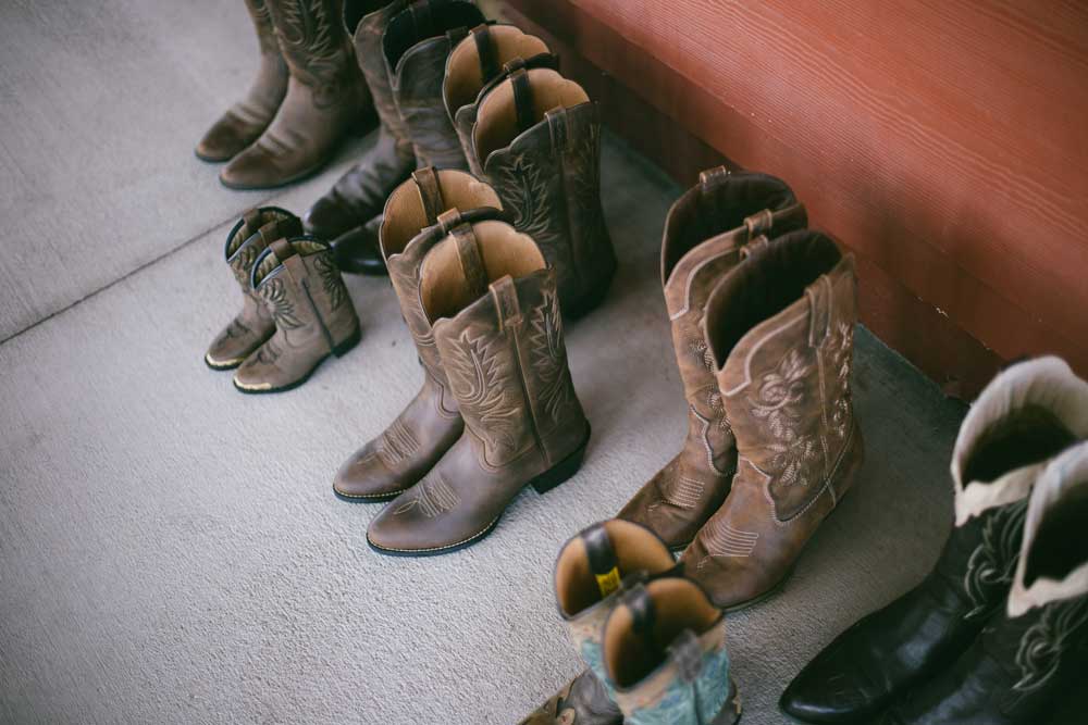 An arrangement of multiple pairs of cowboy boots