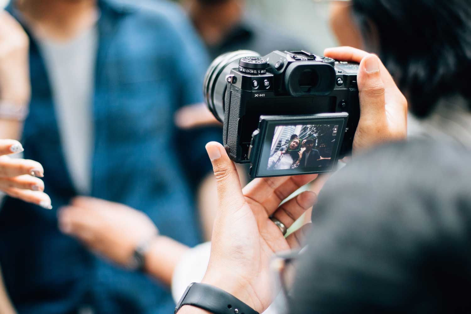 Hands holding a camera.